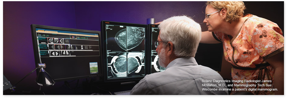 Dr. James McMahon and Sue Wiscombe review a digital mammogram
