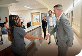 Rounding with other executive leaders, NorthBay Health President and CEO Mark Behl shakes hands with Kim McQueen, Clinical Manager for the medical/surgical wing on 2 North at NorthBay Health Medical Center.